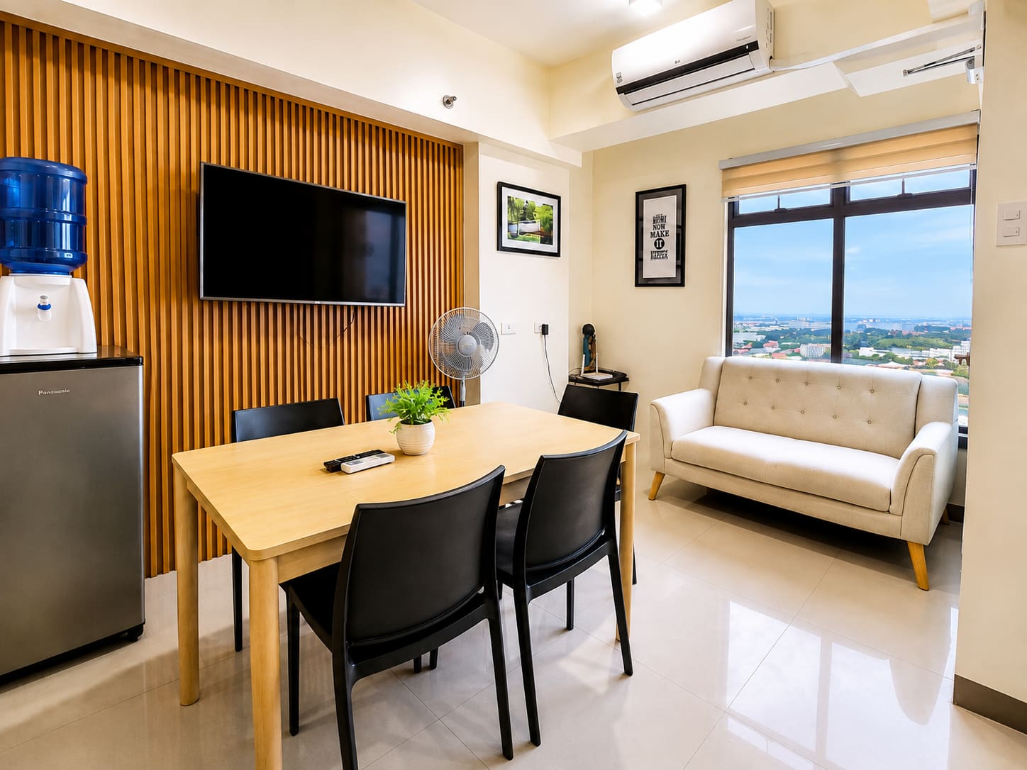 Dining table for six in front of the wood-slat TV wall, with a loveseat by the city-view window