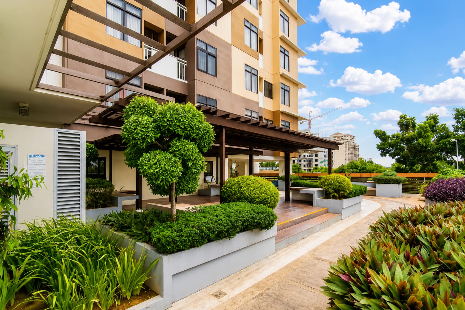 Eco garden with a wooden pergola and planted walkways at Mabolo Garden Flats