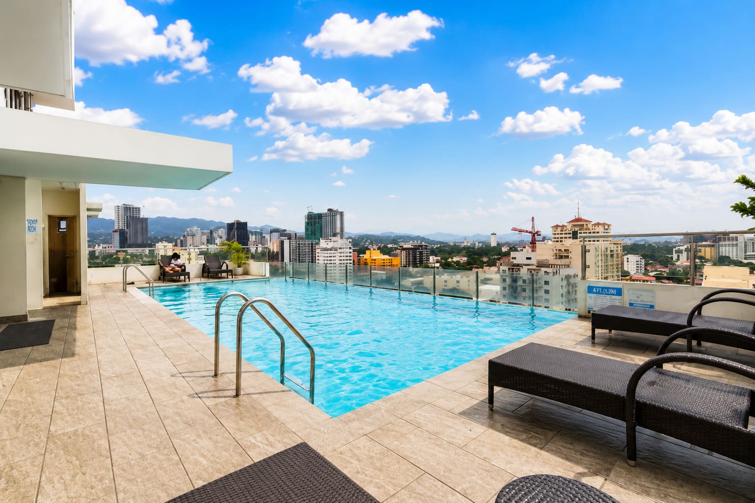 Infinity pool on the 17th floor of Mabolo Garden Flats, overlooking the Cebu City skyline and mountains